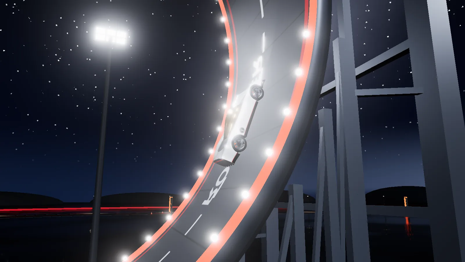 A Tesla Roadster wrap hanging upside down on the curved launch ramp at night